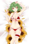  1girl armpits bikini breasts commentary_request dai_zu_san dakimakura_(medium) eyebrows_visible_through_hair flower green_hair green_nails hair_between_eyes highres kazami_yuuka large_breasts lying navel on_back on_bed petals red_eyes red_nails short_hair solo sunflower swimsuit thigh_strap thong_swimsuit touhou 