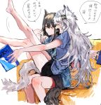  2girls animal_ears arknights arm_around_shoulder bare_legs barefoot black_hair black_shorts blue_shirt blush book closed_mouth commentary_request couch cup eyebrows_visible_through_hair fang grey_hair highres holding holding_book holding_cup lappland_(arknights) legs_up long_hair multiple_girls na_tarapisu153 on_couch open_mouth parted_lips shirt short_sleeves shorts sitting sitting_on_lap sitting_on_person skin_fang speech_bubble t-shirt tail texas_(arknights) translation_request wolf_ears wolf_girl wolf_tail yellow_eyes 