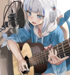  1girl acoustic_guitar animal_hood bangs blue_eyes blue_hair blue_hoodie blunt_bangs blush drawstring eyebrows_visible_through_hair fish_tail gawr_gura guitar hair_ornament hairclip hani_haya highres hololive hololive_english hood hood_down hoodie instrument long_hair long_sleeves microphone multicolored_hair music open_mouth playing_instrument recording_studio shark_hood shark_tail sharp_teeth silver_hair sleeves_rolled_up solo streaked_hair studio_microphone tail teeth virtual_youtuber 