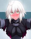  1girl ahoge black_cape blonde_hair blush breasts cape chain clenched_teeth embarrassed fate/grand_order fate_(series) feather_trim full-face_blush hasebe_akira highres jeanne_d&#039;arc_(alter)_(fate) jeanne_d&#039;arc_(fate)_(all) looking_at_viewer medium_breasts solo sweatdrop tearing_up teeth wall_slam yellow_eyes 