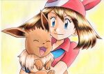  1girl bangs blue_eyes brown_hair closed_mouth collared_shirt commentary_request eevee eyelashes gloves highres holding holding_pokemon long_hair looking_down may_(pokemon) oka_mochi pokemon pokemon_(anime) pokemon_(creature) pokemon_rse_(anime) red_bandana red_shirt shiny shiny_hair shirt short_sleeves smile traditional_media upper_body white_gloves yellow_background 