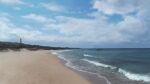  beach bird building cloud cloudy_sky commentary ito_eri lighthouse no_humans original sand scenery sky waves 