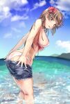  1girl ass bikini blush breasts brown_eyes brown_hair clothes_pull cutoffs denim denim_shorts flower from_side hair_flower hair_ornament highres kudou_maimu large_breasts long_hair looking_at_viewer ocean open_mouth original short_shorts shorts shorts_pull solo swimsuit twitter_username wading water wet white_bikini 