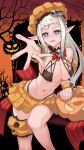  1girl black_bra blush bra braid breasts cleavage eyebrows_visible_through_hair fangs fangs_out feet_out_of_frame girls&#039;_frontline halloween halloween_bucket halloween_costume happy_halloween highres jamgom long_hair looking_at_viewer medium_breasts mp5_(girls&#039;_frontline) navel open_mouth orange_skirt pointy_ears pumpkin_hat purple_eyes silver_hair sitting skirt smile solo underwear 