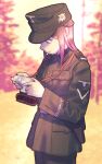 1girl belt belt_buckle blue_eyes blurry blurry_background braid breast_pocket brown_hair buckle buttons camera commentary_request cowboy_shot edelweiss_(flower) forest germany hat holding holding_camera holster insignia karasumi_(sumizono) looking_at_object m43_field_cap medium_hair military military_hat military_uniform nature nazi original pocket sidelocks soldier solo ss_insignia strap swastika totenkopf uniform upper_body waffen-ss world_war_ii 