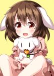  1girl :d animal animal_ears bangs brown_hair bunny carrot_necklace dress eyebrows_visible_through_hair floppy_ears highres holding holding_animal in_mouth inaba_mob_(touhou) inaba_tewi looking_at_viewer open_mouth pink_dress puffy_short_sleeves puffy_sleeves rabbit_ears rabbit_tail ruu_(tksymkw) short_hair short_sleeves simple_background sitting smile solid_oval_eyes tail touhou yellow_background 