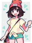 1girl :d bangs beanie border bracelet brown_hair clenched_hand commentary eyelashes floral_print green_shorts hand_up hat heart highres jewelry open_mouth pokemon pokemon_(game) pokemon_sm red_eyes red_headwear selene_(pokemon) shiny shiny_skin shirt short_shorts short_sleeves shorts smile solo t-shirt tied_shirt tongue touyarokii 