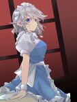  1girl absurdres apron back_bow bangs blue_dress blue_eyes bow braid dot_mouth dress eyebrows_visible_through_hair frilled_apron frilled_skirt frills green_bow hair_between_eyes hair_bow hair_ribbon hand_on_table highres ichimura_kanata izayoi_sakuya looking_at_viewer maid maid_apron maid_headdress medium_hair puffy_short_sleeves puffy_sleeves red_background ribbon short_hair short_sleeves silver_hair simple_background skirt standing table touhou tress_ribbon twin_braids waist_apron white_bow window wrist_cuffs 