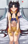  1girl bangs bare_shoulders belt black_hair blue_bandeau blush breasts cleavage cropped_vest earrings fate/grand_order fate_(series) fingerless_gloves gloves grin hair_ribbon highres hoop_earrings ishtar_(fate) jewelry long_hair looking_at_viewer medium_breasts multicolored_hair navel on_bed parted_bangs recording red_eyes red_hair ribbon sarhce short_shorts shorts sitting smile solo space_ishtar_(fate) tiara two-tone_hair two_side_up vest yellow_gloves yellow_shorts yellow_vest 