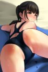  1girl ass back bangs beach_towel black_hair black_swimsuit blush brown_eyes closed_mouth commentary_request eyebrows_visible_through_hair highres looking_at_viewer looking_back lying matsunaga_kouyou on_stomach one-piece_swimsuit original partially_visible_vulva ponytail sand sidelocks smile solo swimsuit thighs towel wet 