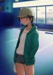  1girl :t baseball_cap breasts closed_mouth commentary_request convenience_store green_jacket hand_in_pocket hashi hat jacket looking_at_viewer medium_breasts open_clothes open_jacket original outdoors shop short_hair short_shorts shorts solo tan tanlines tomboy 
