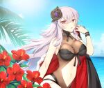  1girl adjusting_clothes azur_lane bangs bikini black_bikini blue_sky breasts cape cleavage cloud cloudy_sky collarbone commentary_request ebino_mayo eyebrows_visible_through_hair flower fur-trimmed_cape fur_trim graf_zeppelin_(azur_lane) graf_zeppelin_(beachside_urd)_(azur_lane) hair_between_eyes hair_ornament horizon long_hair looking_at_viewer midriff navel ocean parted_lips red_eyes sidelocks silver_hair sky solo sunlight swimsuit 