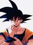  1boy adjusting_clothes backlighting black_eyes black_hair blue_wristband clenched_hand closed_mouth dougi dragon_ball dragon_ball_z grey_background hair_strand hands_up highres kz_(dbz_kz) light_particles looking_at_viewer male_focus muscular muscular_male pectorals simple_background smile solo son_goku spiked_hair upper_body wristband 