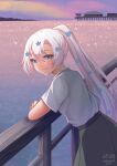  1girl blue_eyes blue_flower character_name closed_mouth flower from_side green_skirt grey_hair hair_flower hair_ornament happy_tears highres horizon indie_virtual_youtuber leaning_forward long_hair looking_at_viewer looking_to_the_side lyrica_(vtuber) ocean outdoors ponytail railing shirt short_sleeves sidelocks signature skirt smile solo tears temachii virtual_youtuber white_shirt 