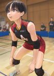  1girl black_hair blurry blurry_background breasts brown_eyes collarbone commentary_request elbow_pads highres indoors knee_pads mole mole_on_arm mole_on_collarbone mole_under_eye original otsu_natsu shoes short_hair shorts small_breasts sneakers solo_focus sportswear standing sweat tomboy volleyball_(sport) 