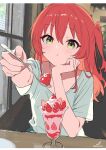  1girl :t absurdres artist_logo artist_name blurry blurry_background blush bocchi_the_rock! closed_mouth collarbone commentary cup drinking_glass feeding_viewer food fruit green_eyes green_shirt hair_between_eyes hand_on_own_chin head_rest highres holding holding_spoon ice_cream_spoon indoors kita_ikuyo light_blush logo long_hair looking_at_viewer minusk9 one_side_up outstretched_arm parfait parfait_glass pov_across_table reaching reaching_towards_viewer red_hair shirt short_sleeves solo spoon strawberry strawberry_parfait table twitter_username upper_body window 
