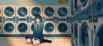  1girl :| bangs black_hair blue_skirt blush brown_eyes chinese_commentary closed_mouth commentary highres laundromat long_hair long_sleeves looking_at_viewer maionese neckerchief on_floor original reflection scenery school_uniform serafuku serious sitting skirt socks solo tile_floor tiles wariza washing_machine wide_shot 