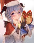  1girl bangs bell black_gloves blue_hair blush bow breasts capelet christmas commentary detached_sleeves eyebrows_visible_through_hair ganyu_(genshin_impact) genshin_impact gift gloves gold_trim hat highres holding holding_gift horns long_hair looking_at_viewer merry_christmas neck_bell purple_eyes red_capelet santa_hat sidelocks smile solo upper_body ura_illust white_sleeves 
