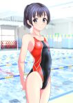  1girl absurdres arms_behind_back black_hair blurry blurry_background breasts brown_eyes clothes_writing competition_swimsuit cowboy_shot highres lane_line logo looking_at_viewer multicolored_clothes multicolored_swimsuit one-piece_swimsuit original ponytail pool short_hair short_ponytail small_breasts smile solo standing string_of_flags swimsuit takafumi 