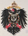  2019 accipitrid accipitriform avian beak bird black_body black_feathers carving christian_cross christian_symbol christianity cross crown crucifix eagle feathered_wings feathers feral german german_empire germany hi_res jewelry markhor_(artist) necklace painted photo red_beak red_feet regalia religion ribbons shield solo tail_feathers wings wood yellow_beak yellow_feet 
