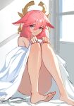  1girl animal_ears bed_sheet commentary completely_nude earrings fox_ears full_body genshin_impact hair_between_eyes highres indoors jason_kim jewelry long_hair looking_at_viewer naked_sheet nude on_bed parted_lips pink_hair purple_eyes sitting smile solo toes yae_(genshin_impact) 