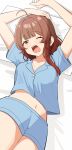  1girl absurdres ahoge aroon blue_pajamas blue_shirt blue_shorts breasts brown_eyes brown_hair commentary_request gakuen_idolmaster hanami_ume highres idolmaster large_breasts looking_at_viewer midriff navel one_eye_closed open_mouth pajamas pillow shirt short_shorts short_sleeves shorts solo stretching waking_up yawning 