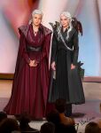 2girls 6+others a_song_of_ice_and_fire absurdres ancestor_and_descendant benophiedara closed_mouth commentary daenerys_targaryen dragon dress drogon english_commentary full_body game_of_thrones green_dress highres house_of_the_dragon jewelry lips long_hair looking_at_viewer microphone_stand mixed_media multiple_girls multiple_others necklace photo-referenced photo_background red_dress rhaegal rhaenyra_targaryen standing viserion western_dragon white_hair 