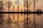  artist_request bicycle biker child commentary_request english_commentary ground_vehicle highres lake lightning original outdoors reflection scenery serenity silhouette sunrise sunset water 
