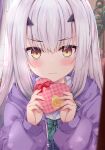  1girl blush candy chocolate commentary fairy_knight_lancelot_(fate) fate/grand_order fate_(series) food frown grey_hair heart heart-shaped_chocolate highres holding holding_chocolate holding_food jacket long_hair rioshi yellow_eyes 