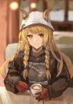  1girl absurdres animal_ears arknights artist_name bangs belt blonde_hair blurry blurry_background braid ceobe_(arknights) ceobe_(unfettered)_(arknights) chain closed_mouth collared_jacket cup dog_ears dog_girl ears_through_headwear eyebrows_visible_through_hair gloves highres holding holding_cup indoors jacket long_hair looking_at_viewer milbi orange_eyes oversized_clothes red_gloves sitting smile solo sweater table twin_braids white_headwear 