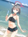  1girl absurdres bangs beach bikini black_bikini black_hair blue_archive blurry bokeh bow bow_hairband cowboy_shot dated depth_of_field dutch_angle food frilled_bikini frills hairband halo highres holding holding_food light_blush light_smile looking_at_viewer mashiro_(blue_archive) midriff navel no_wings outdoors popsicle purple_eyes short_hair signature solo swimsuit utachy water white_bow white_hairband 