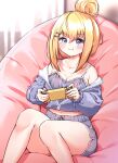  1girl :t bangs bare_shoulders bean_bag_chair blonde_hair blue_eyes blush breasts camisole cleavage collarbone dolphin_shorts eyebrows_visible_through_hair game_console habetrot_(last_origin) hair_between_eyes hair_bun handheld_game_console highres holding holding_handheld_game_console ine_(ineinnen) jacket jacket_on_shoulders joy-con last_origin looking_at_viewer midriff navel nintendo_switch playing_games pout short_shorts shorts sitting solo spaghetti_strap tears 