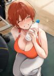  1girl absurdres akito_(d30n26) ball bangs bare_shoulders bottle breasts breath cleavage closed_eyes collarbone dumbbell exercise_ball eyebrows_visible_through_hair from_above grin hair_between_eyes highres holding holding_bottle large_breasts looking_at_viewer looking_up nagi_(akito) orange_sports_bra original pants raised_eyebrows red_hair short_hair smile solo sports_bra sportswear squatting sweat water_bottle yoga_mat yoga_pants 