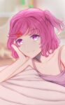  1girl bed bed_sheet closed_mouth doki_doki_literature_club elbow_rest hair_ornament hairclip hand_on_own_cheek hand_on_own_face head_on_hand head_rest highres leguma looking_at_viewer natsuki_(doki_doki_literature_club) pink_eyes pink_hair pink_tank_top short_hair short_twintails smile solo tank_top twintails 