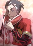  1boy black_hair bright_pupils closed_mouth commentary_request grey_hair highres kabu_(pokemon) kotobukkii_(yt_lvlv) male_focus multicolored_hair multicolored_towel pokemon pokemon_swsh print_shirt red_background red_eyes red_shirt red_towel shirt short_hair solo two-tone_hair upper_body white_towel 
