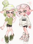  2girls :o bike_shorts black_shorts collared_shirt commentary_request double_bun eyewear_on_head fang flower_(symbol) full_body green_footwear green_hair green_headwear green_shirt grey_eyes hair_bun hand_on_own_hip highres inkling inkling_girl inkling_player_character lemo_(lemo_4) long_sleeves multiple_girls open_mouth pink_hair polo_shirt sandals shirt short_hair short_sleeves shorts splatoon_(series) sweater tentacle_hair visor_cap white-framed_eyewear white_background white_footwear white_sweater 