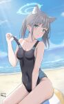  1girl absurdres animal_ear_fluff animal_ears bare_arms bare_legs bare_shoulders beach black_one-piece_swimsuit blue_archive blue_eyes blue_halo blush breasts cleavage commentary competition_swimsuit dated day extra_ears grey_hair halo highres kippei looking_at_viewer medium_breasts medium_hair mismatched_pupils ocean official_alternate_costume one-piece_swimsuit open_mouth outdoors shiroko_(blue_archive) shiroko_(swimsuit)_(blue_archive) signature solo swimsuit wolf_ears 