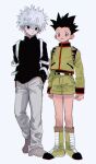  2boys black_eyes black_hair black_shirt boots brown_eyes child gon_freecss hunter_x_hunter killua_zoldyck long_sleeves male_focus multiple_boys shirt shorts smile standing torohiko white_background white_hair 