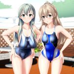  2girls absurdres beach_umbrella blue_swimsuit clothes_writing competition_swimsuit cowboy_shot fence green_eyes grey_swimsuit hair_ornament hairclip hands_on_hips highres kantai_collection kumano_(kancolle) leaning_forward long_hair looking_at_viewer multicolored_clothes multicolored_swimsuit multiple_girls one-piece_swimsuit silver_hair suzuya_(kancolle) swimsuit table takafumi umbrella 