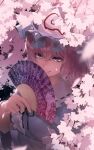  1girl :q arm_under_breasts bangs black_ribbon blue_headwear blue_kimono center_frills cherry_blossoms commentary folding_fan frilled_shirt_collar frills goshoguruma hair_between_eyes hand_fan hand_up hat highres holding holding_fan japanese_clothes kimono licking_lips light_purple_eyes looking_at_viewer mob_cap monosenbei neck_ribbon pink_eyes pink_hair ribbon ribbon-trimmed_collar ribbon_trim saigyouji_yuyuko saigyouji_yuyuko&#039;s_fan_design short_hair solo tongue tongue_out touhou triangular_headpiece upper_body wide_sleeves 