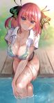  1girl absurdres bangs blue_eyes blush bra breasts cleavage collarbone go-toubun_no_hanayome green_bra highres large_breasts looking_at_viewer medium_hair nakano_nino see-through shirt short_sleeves sitting solo underwear wet wet_bra wet_clothes white_shirt yousuketwelve 