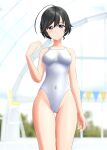  1girl absurdres ahoge black_eyes black_hair blurry blurry_background breasts commentary_request competition_swimsuit covered_navel cowboy_shot girls_und_panzer highres indoors isuzu_hana long_hair medium_breasts one-piece_swimsuit solo string_of_flags swimsuit takafumi thigh_gap updo white_swimsuit 