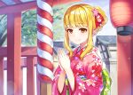  1girl bangs blonde_hair blunt_bangs day eyebrows_visible_through_hair floral_print hair_bun hair_ornament japanese_clothes kimono lantern monster_company obi official_art orange_eyes outdoors own_hands_together paper_lantern pink_kimono ringozaka_mariko sash shrine smile solo stone_lantern upper_body 