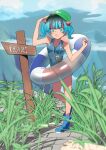  1girl :o absurdres arm_up bangs blue_eyes blue_footwear blue_hair boots breasts cabbie_hat collarbone commentary_request eyelashes full_body grass green_headwear hair_bobbles hair_ornament hat highres jphspsu0712 kawashiro_nitori key medium_breasts open_mouth signpost solo standing striped_innertube swimsuit touhou two_side_up 