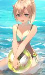  1girl aqua_eyes ball beach bikini blonde_hair breasts cowengium flower green_bikini highres holding holding_ball hololive kazama_iroha long_hair looking_at_viewer medium_breasts open_mouth own_hands_together partially_submerged pokobee ponytail side-tie_bikini sidelocks sitting solo swimsuit virtual_youtuber wariza water 