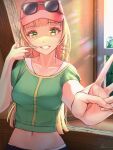  1girl bangs baseball_cap blonde_hair blunt_bangs breasts crop_top day drill_hair english_commentary eyebrows_visible_through_hair eyewear_on_headwear finger_gun fingersmile green_eyes green_shirt grin hand_up hat heanna_sumire highres indoors long_hair looking_at_viewer love_live! love_live!_superstar!! medium_breasts midriff navel notinversion outstretched_arm shirt sidelocks signature smile solo stomach straight_hair sunglasses sunlight teeth upper_body v window 
