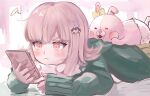  1girl blush bow brown_skirt closed_mouth danganronpa_(series) danganronpa_2:_goodbye_despair ear_bow green_jacket highres holding holding_phone jacket long_sleeves lying medium_hair monomi_(danganronpa) mw_muu_(t0toro_oekaki) nanami_chiaki on_stomach phone pink_eyes pout skirt sleeves_past_wrists solo spaceship_hair_ornament 