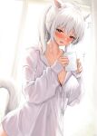  1girl :d ahoge animal_ears blush borrowed_clothes breasts buttons cat_ears cat_girl cat_tail cleavage collarbone cup highres holding holding_cup indoors large_breasts long_hair long_sleeves looking_at_viewer mug open_mouth original red_eyes shhilee shirt smile solo sweat tail translation_request white_hair white_shirt 