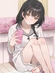  1girl bare_legs black_hair blush breasts cellphone cherry_print cleavage commentary_request feet_out_of_frame food_print head_tilt highres holding holding_phone idolmaster idolmaster_shiny_colors indoors knees_up looking_at_phone mayuzumi_fuyuko phone sitting sleepwear solo yumeme_818 