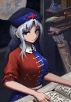  1girl arrow_(projectile) blue_eyes blue_headwear book bow clear_ice cross eyebrows_visible_through_hair grey_hair long_hair looking_at_viewer moon smile solo touhou yagokoro_eirin 